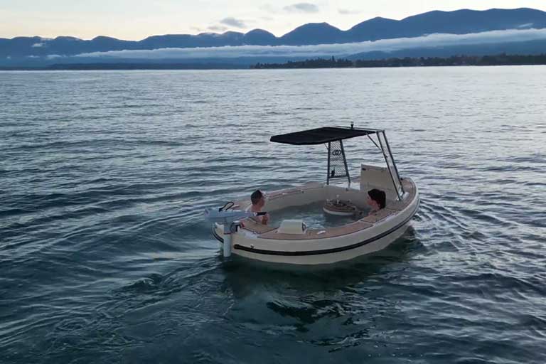 Enjoy warm waters and a cozy fireplace with the Spacruzzi Hot Tub Boat.